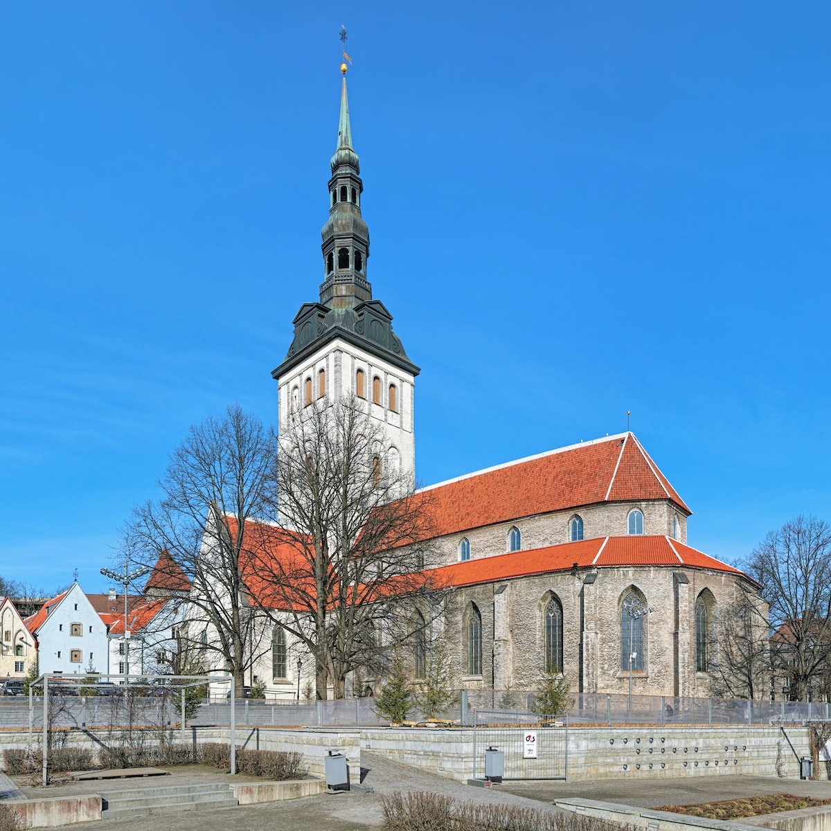 Tallinn, Estonia - March 19, 2015: St. Nicholas Church (Niguliste kirik) and cupola of Alexander Nevsky Cathedral. The St. Nicholas Church was founded and built around 1230-1275. Today it houses a branch of the Art Museum of Estonia.