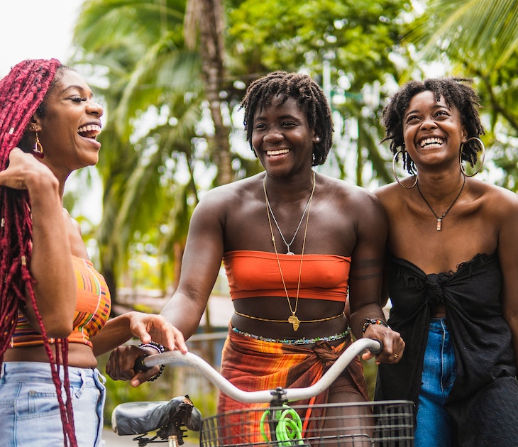 Stock photo of happy female friends laughing and talking in the streets of Costa Rica.